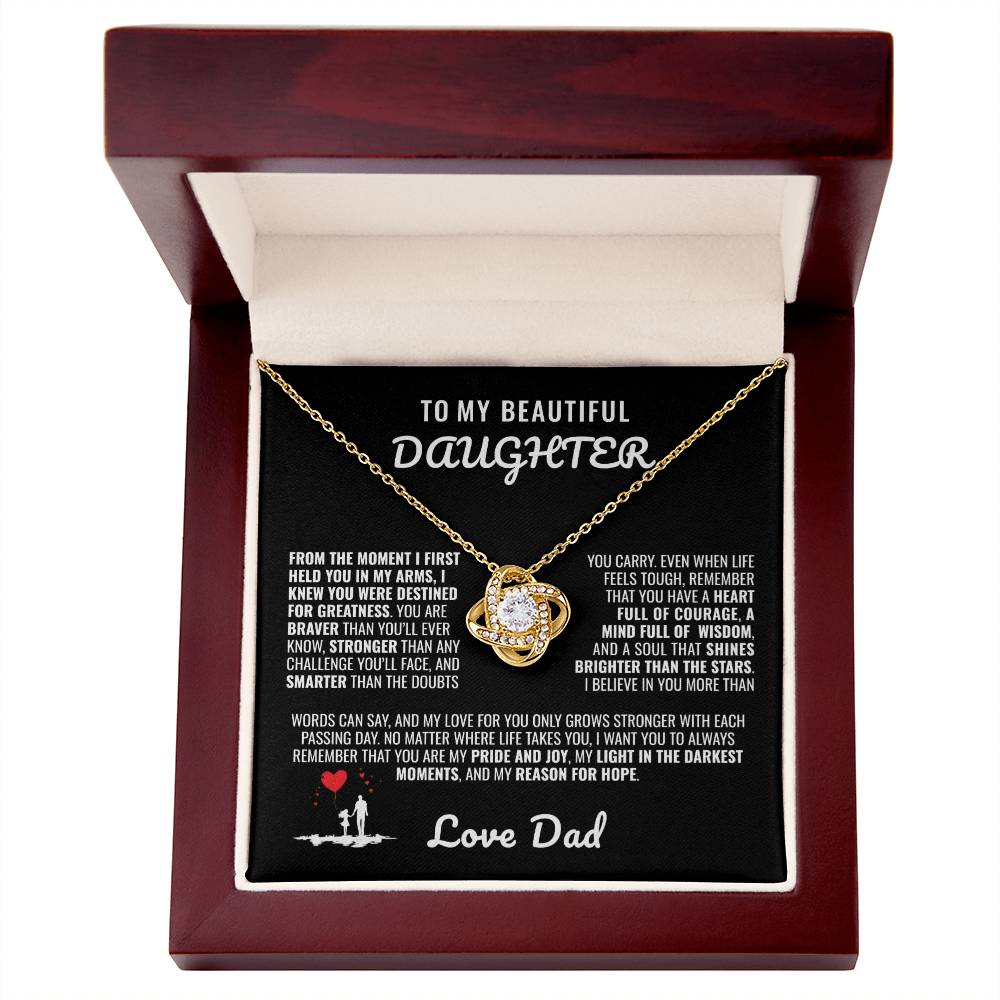 Elegant silver love knot necklace with a sparkling crystal, displayed in a black gift box featuring a heartfelt message from a father to his daughter.