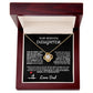 Elegant silver love knot necklace with a sparkling crystal, displayed in a black gift box featuring a heartfelt message from a father to his daughter.
