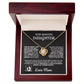 Gold love knot necklace with a sparkling crystal, presented in a gift box with a heartfelt message from a mother to her daughter