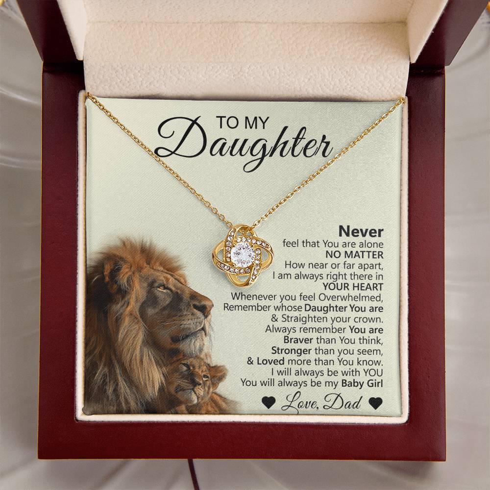 The To My Daughter – Love Knot Necklace is shown in a jewelry box with a circular pendant, accompanied by a heartfelt lion and cub message card—an ideal gift from father to daughter.