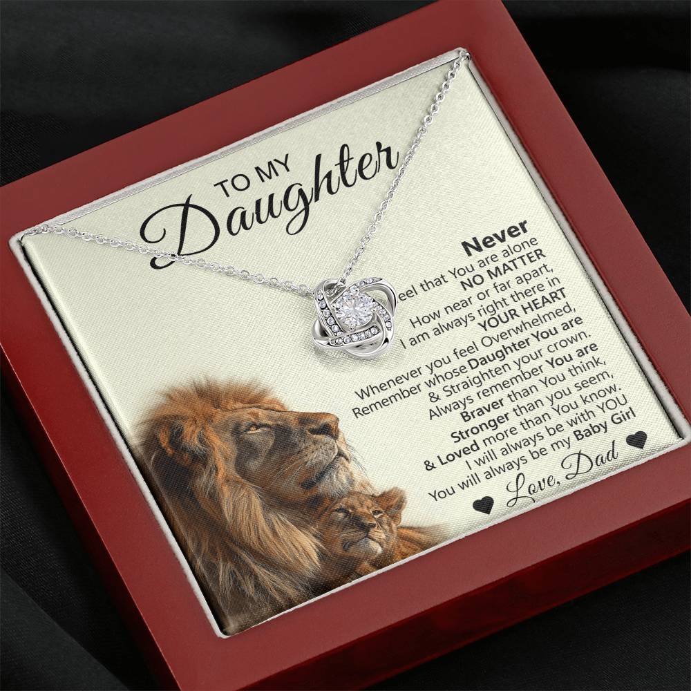 The To My Daughter – Love Knot Necklace with Lion & Cub Message Card features a silver necklace in a red box and a heartfelt note signed Love, Dad with heart symbols—an ideal gift for your daughter.
