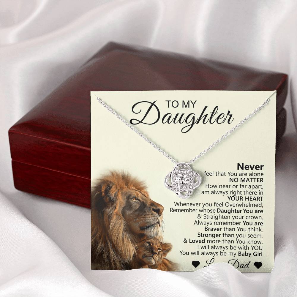The To My Daughter – Love Knot Necklace with Lion & Cub Message Card is a heartfelt daughter gift, featuring a necklace resting on an illustrated card with lion and cub, displayed in front of a red jewelry box.