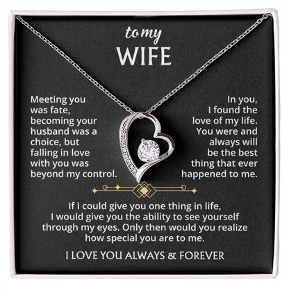 The To My Wife – Forever Love Necklace with Message of Fate and Devotion features a silver heart-shaped pendant with a dazzling crystal, displayed in a gift box. The lid includes a touching message—perfect as an anniversary gift for your wife.
