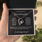 A hand holds a gift box containing the To My Beautiful Granddaughter - Forever Love Necklace with Heartfelt Message Card, featuring a heart-shaped pendant with a smaller heart and shimmering cubic zirconia. Its gold finish adds elegance, expressing love and eternal affection for a granddaughter.