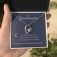 A hand presents a jewelry box with the To My Granddaughter - Forever Love Necklace and a message card that reads: No matter where we are, side by side or miles apart. You will always be in my heart. I love you to the moon and back.