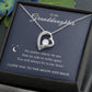 The To My Granddaughter - Forever Love Necklace with Heartfelt Message Card features a silver heart-shaped pendant with a CZ crystal centerpiece, presented in a box reading, To My Granddaughter: No matter the distance, youre always in my heart. I love you to the moon and back. It has a white gold finish.