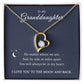 The To My Granddaughter - Forever Love Necklace features a radiant CZ crystal and white gold finish, presented in a gift box on navy blue. The card reads: To My Granddaughter... You will always be in my heart. I love you to the moon and back, with moon and stars graphics.