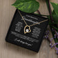 The Forever Love Necklace, presented in a black box, features a gold heart with a central cubic zirconia crystal. The lid displays an emotional message for a granddaughter, encircled by green leaves and purple flowers.