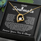 Gold heart pendant necklace with a sparkling crystal, displayed in a wooden gift box with a romantic message for a soulmate, surrounded by rose petals.