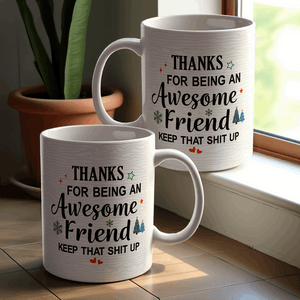 White ceramic mug with a humorous message thanking an awesome friend, decorated with festive elements like snowflakes and trees.